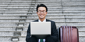 A diverse group of expats working together in a modern office in Cambodia, with a backdrop of Phnom Penh's skyline