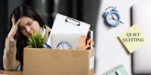 An employee sitting at a desk, disengaged from work, symbolizing quiet quitting in the workplace.